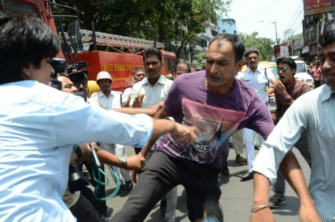 Photojournalists attacked by police driver covering fire in India